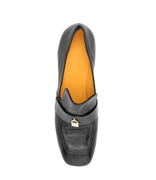 A leather loafer with a block heel, square toe, and a small metal lock detail centered on the upper strap. Designed by Madison in Beverly Hills and handcrafted in Italy.