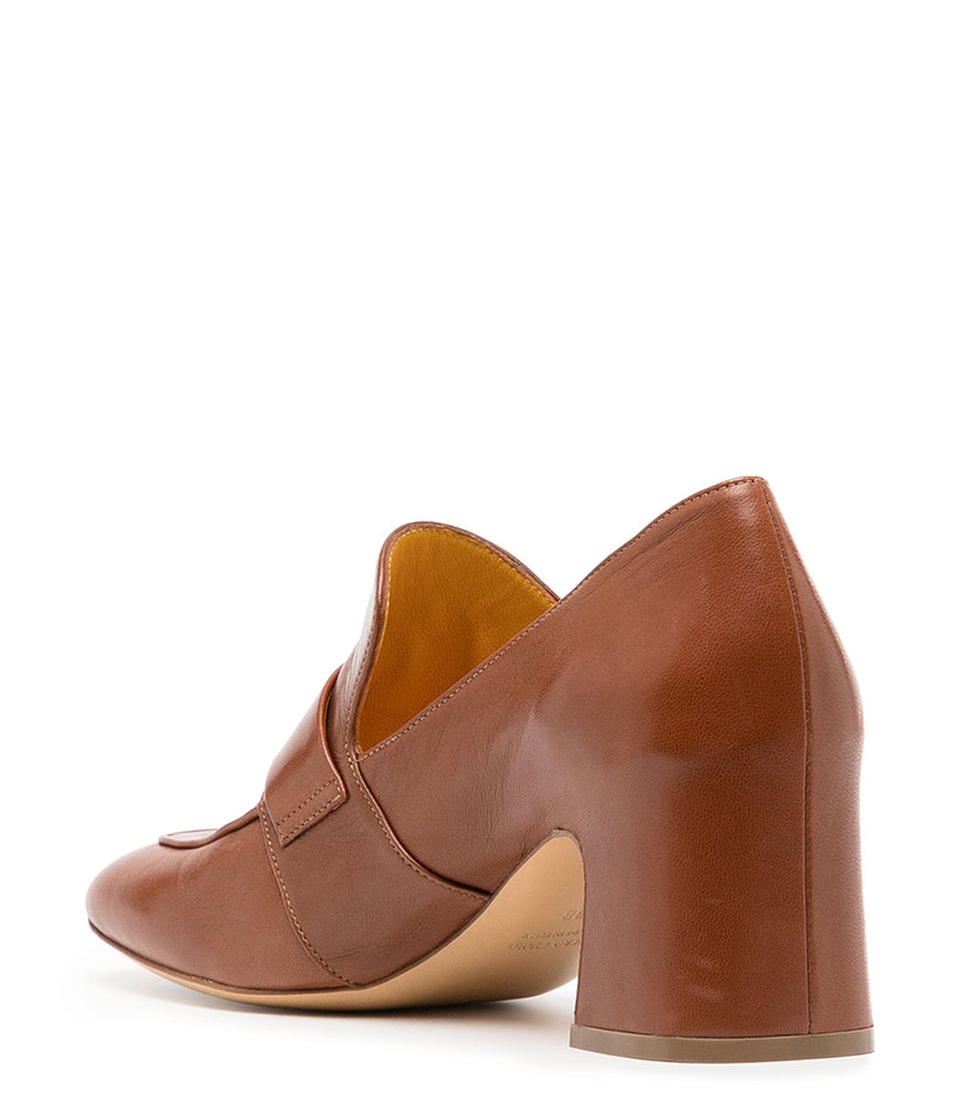 
                      
                        A leather loafer with a block heel, square toe, and a small metal lock detail centered on the upper strap. Designed by Madison in Beverly Hills and handcrafted in Italy.
                      
                    