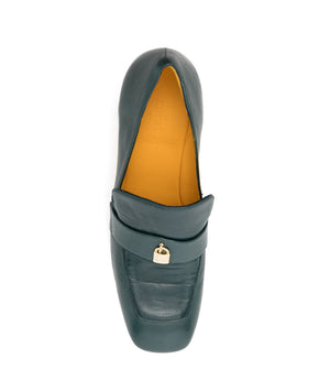 A leather loafer with a block heel, square toe, and a small metal lock detail centered on the upper strap. Designed by Madison in Beverly Hills and handcrafted in Italy.