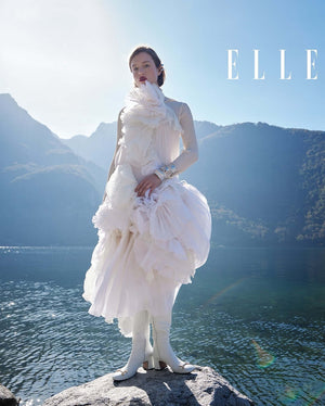 A tall leather boot with a block heel and rounded toe, featuring a metal horsebit-style detail at the front and a small metal padlock accent near the top of the shaft. Designed by Madison in Beverly Hills and handcrafted in Italy