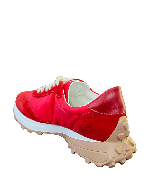 Handcrafted low-top sneaker made in Italy, featuring mixed-material construction with a star-shaped side detail, textured sole, and cushioned laces. Presented from multiple angles against a clean background.