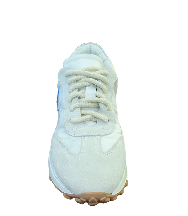 Handcrafted low-top sneaker made in Italy, featuring mixed-material construction with a star-shaped side detail, textured sole, and cushioned laces. Presented from multiple angles against a clean background.