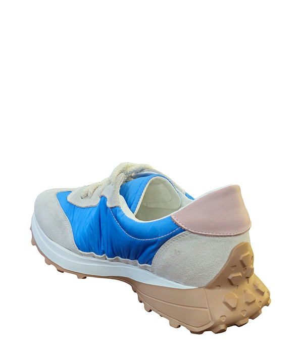 Handcrafted low-top sneaker made in Italy, featuring mixed-material construction with a star-shaped side detail, textured sole, and cushioned laces. Presented from multiple angles against a clean background.