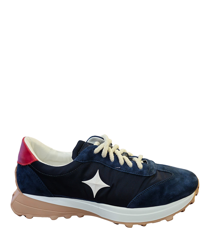 Handcrafted low-top sneaker made in Italy, featuring mixed-material construction with a star-shaped side detail, textured sole, and cushioned laces. Presented from multiple angles against a clean background.