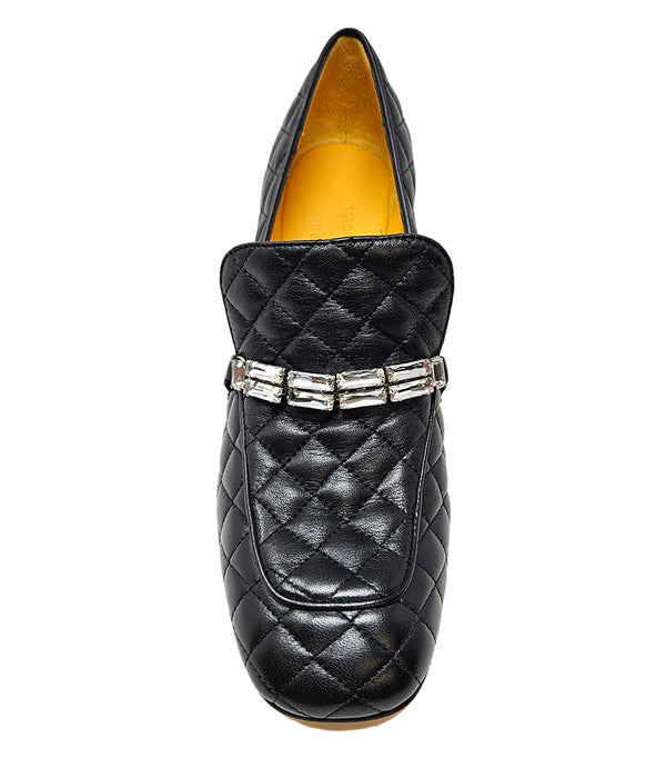A quilted leather heeled loafer with a square toe and block heel, featuring a decorative band with rectangular gemstone-style embellishments across the upper. Designed by Madison in Beverly Hills and handcrafted in Italy