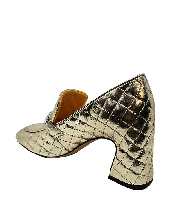 A quilted leather heeled loafer with a square toe and block heel, featuring a decorative band with rectangular gemstone-style embellishments across the upper. Designed by Madison in Beverly Hills and handcrafted in Italy