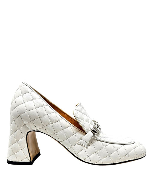 A quilted leather heeled loafer with a square toe and block heel, featuring a decorative band with rectangular gemstone-style embellishments across the upper. Designed by Madison in Beverly Hills and handcrafted in Italy