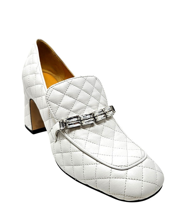 A quilted leather heeled loafer with a square toe and block heel, featuring a decorative band with rectangular gemstone-style embellishments across the upper. Designed by Madison in Beverly Hills and handcrafted in Italy