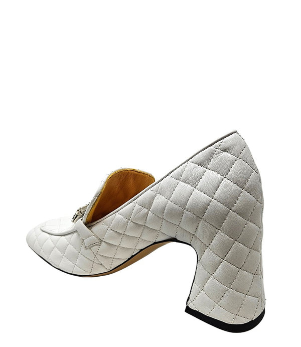 A quilted leather heeled loafer with a square toe and block heel, featuring a decorative band with rectangular gemstone-style embellishments across the upper. Designed by Madison in Beverly Hills and handcrafted in Italy