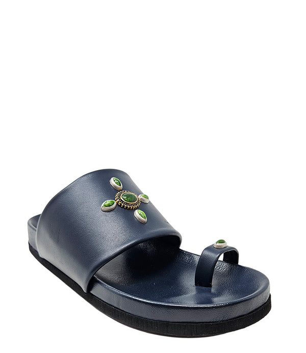 Open-toe flat sandal with a wide front strap and toe loop, embellished with central and side-set decorative stones. Features a contoured footbed and a low-profile sole.