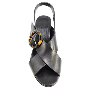 Black sandal with a decorative buckle on a white background