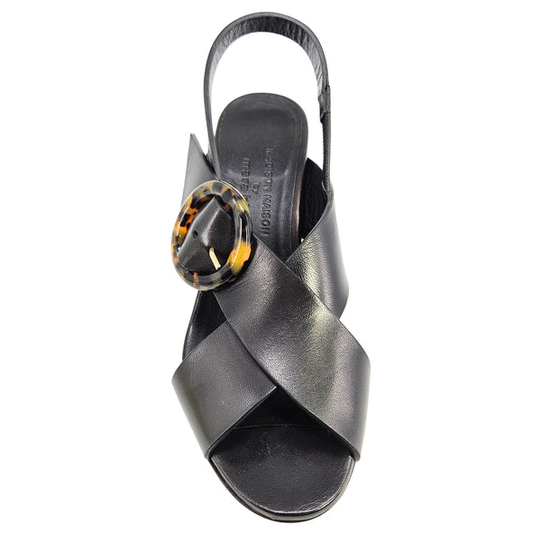 Black sandal with a decorative buckle on a white background
