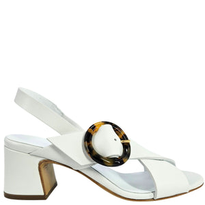 White sandal with a tortoiseshell ring on a white background