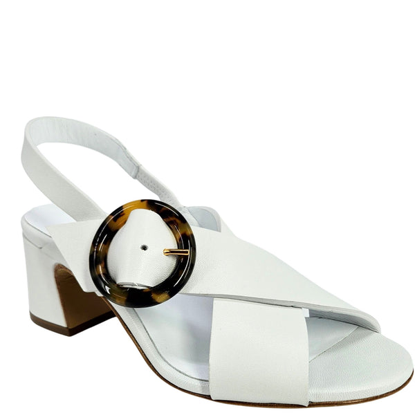White sandal with a tortoiseshell circular detail on a white background