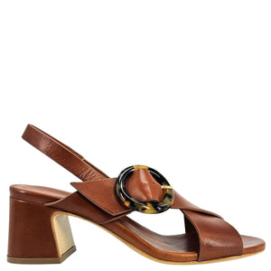 Brown sandal with a decorative buckle on a white background