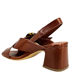 Brown leather sandal with a block heel on a white background