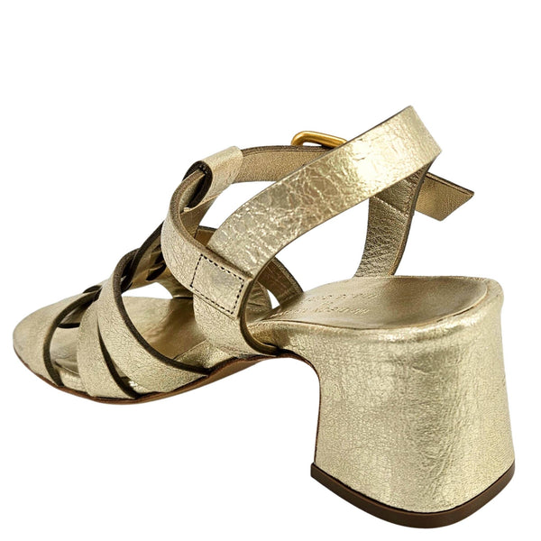 Gold metallic high-heeled sandals on a white background