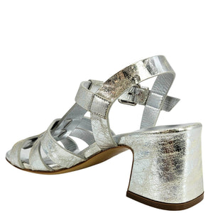 Silver metallic sandal with a block heel on a white background