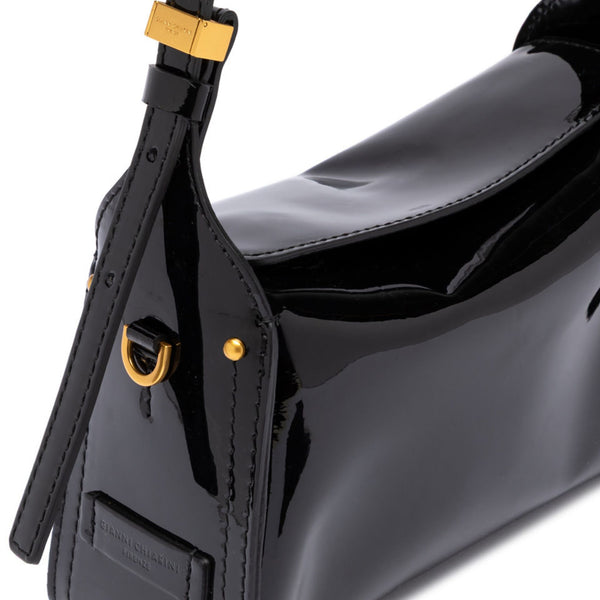 Black glossy handbag with gold hardware on a white background