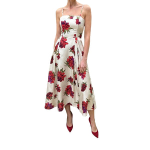 White dress with red floral pattern worn by a person on a white background