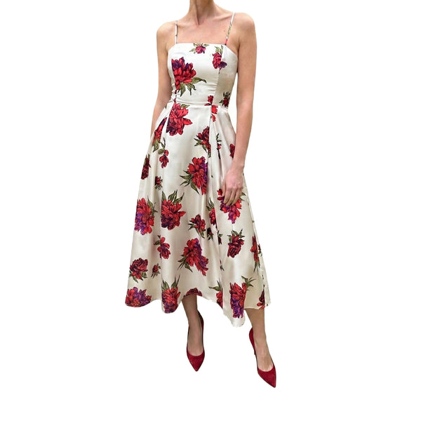 White dress with red floral pattern worn by a person on a white background