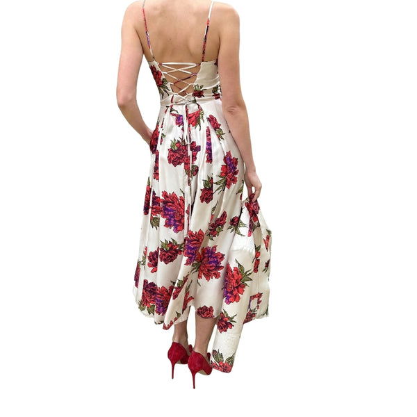 Woman wearing a floral dress with red high heels on a white background