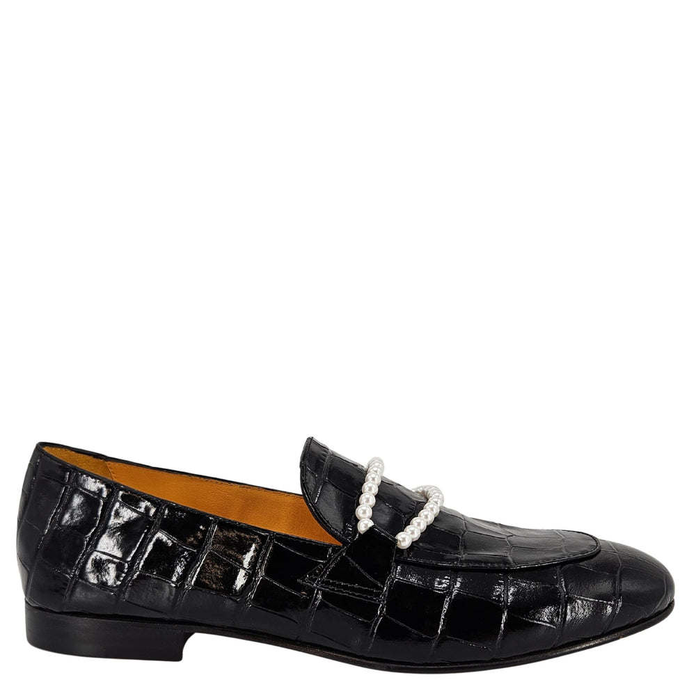 Black crocodile-patterned loafer with a pearl necklace on a white background