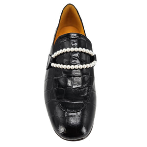 Black loafers with pearl straps on a white background
