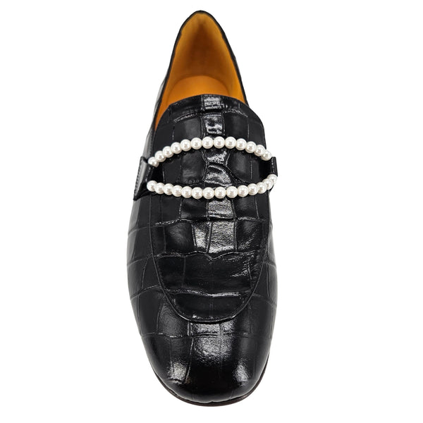 Black loafers with pearl straps on a white background