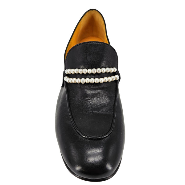 Black loafer with pearl embellishments on a white background