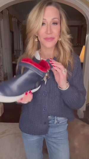 Ankle-high leather sneaker with side zipper closure, cushioned sole, and smooth panel construction. Features a rounded toe, pull tab at the heel, and soft interior lining.