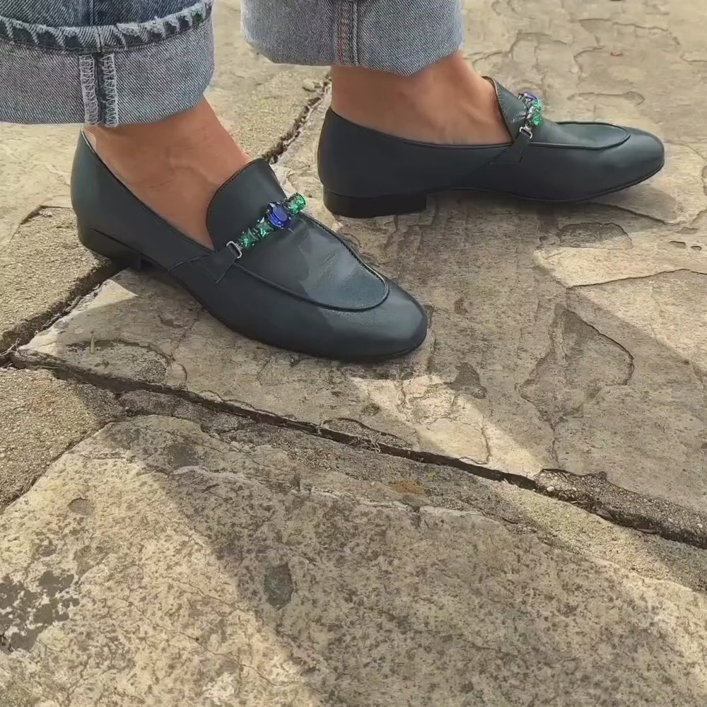 
                      
                        Cargar y reproducir video en el visor de la galería, A leather loafer with a low stacked heel and rounded toe, featuring a decorative band adorned with faceted gemstone-style embellishments across the upper. Designed by Madison in Beverly Hills and handcrafted in Italy
                      
                    