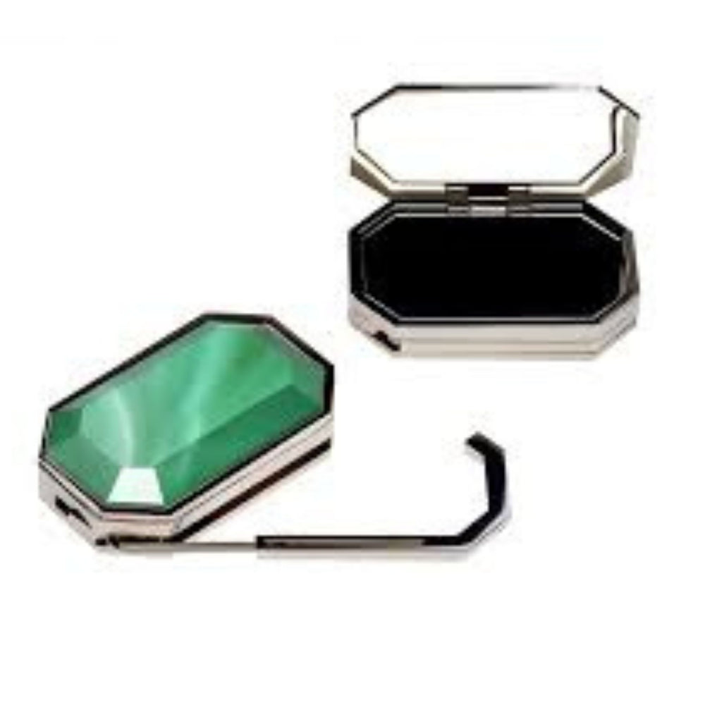Two compact mirrors, one green and one black, on a white background