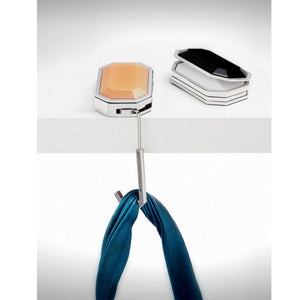 Modern wall hook with a blue scarf on a white background