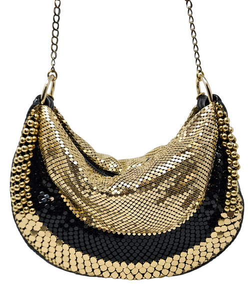 A metallic hobo-style handbag with a black and silver mesh design, accented by large silver beaded trim along the edges. The bag hangs from a silver chain strap and features a soft, slouchy silhouette. Designed by Madison in Beverly Hills