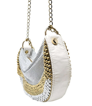 A metallic hobo-style handbag with a black and silver mesh design, accented by large silver beaded trim along the edges. The bag hangs from a silver chain strap and features a soft, slouchy silhouette. Designed by Madison in Beverly Hills