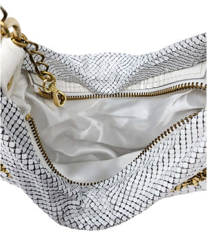 A metallic hobo-style handbag with a black and silver mesh design, accented by large silver beaded trim along the edges. The bag hangs from a silver chain strap and features a soft, slouchy silhouette. Designed by Madison in Beverly Hills