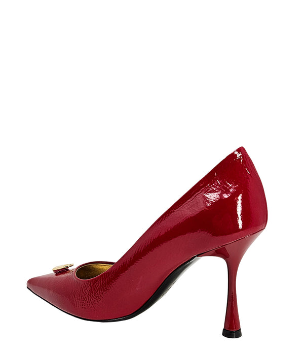 Pointed-toe stiletto pump with a sleek, glossy finish, mid-height heel, and gold lock embellishment at the toe. Features a sculpted silhouette and cushioned interior.