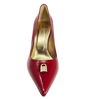 Pointed-toe stiletto pump with a sleek, glossy finish, mid-height heel, and gold lock embellishment at the toe. Features a sculpted silhouette and cushioned interior.
