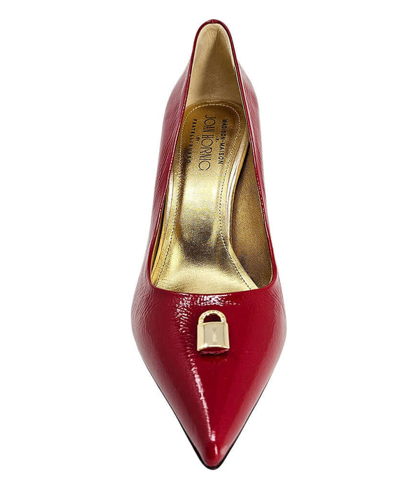 Pointed-toe stiletto pump with a sleek, glossy finish, mid-height heel, and gold lock embellishment at the toe. Features a sculpted silhouette and cushioned interior.