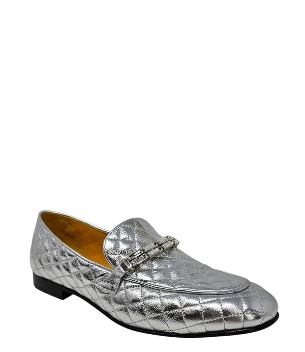A quilted leather flat loafer with a low stacked heel and rounded toe, featuring a decorative strap adorned with rectangular gemstone-style embellishments. Designed by Madison in Beverly Hills and handcrafted in Italy.