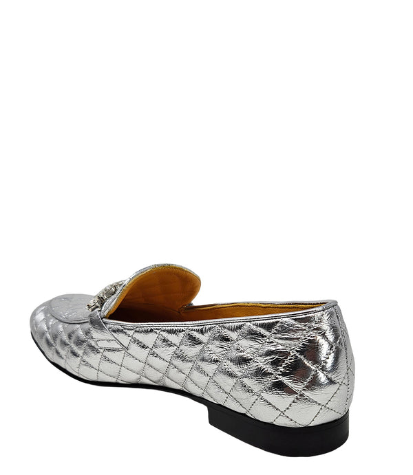 A quilted leather flat loafer with a low stacked heel and rounded toe, featuring a decorative strap adorned with rectangular gemstone-style embellishments. Designed by Madison in Beverly Hills and handcrafted in Italy.