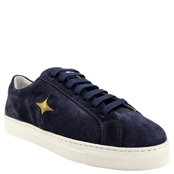 Navy blue suede sneaker with a gold star on a white background