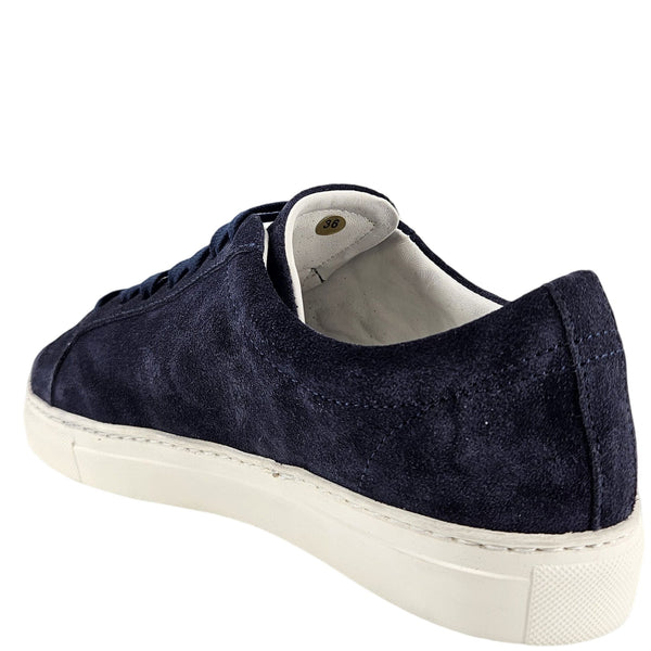 Navy suede sneaker with white sole on a white background