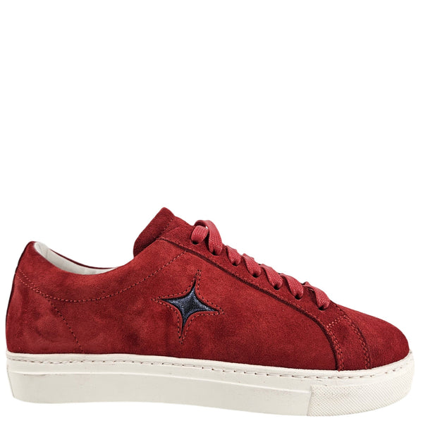 Red sneaker with a black star patch on a white background