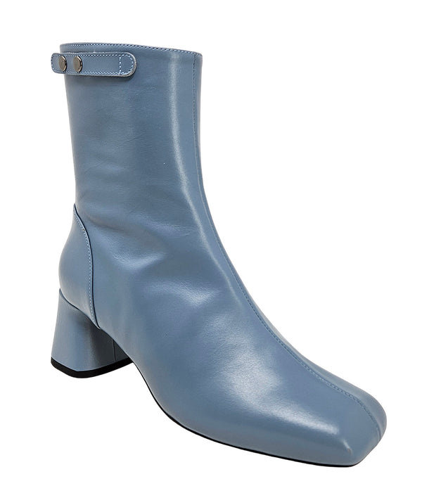 Handcrafted ankle boot made in Italy, designed with a smooth leather finish, square toe, side zipper closure, and a flared block heel. Features a decorative strap with metal accents. Shown from multiple angles against a clean background