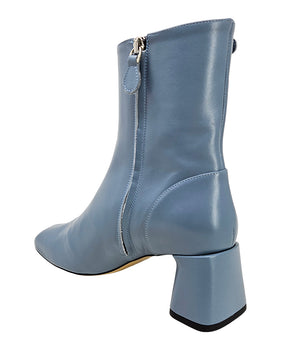 Handcrafted ankle boot made in Italy, designed with a smooth leather finish, square toe, side zipper closure, and a flared block heel. Features a decorative strap with metal accents. Shown from multiple angles against a clean background