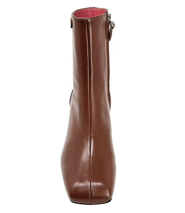 Handcrafted ankle boot made in Italy, designed with a smooth leather finish, square toe, side zipper closure, and a flared block heel. Features a decorative strap with metal accents. Shown from multiple angles against a clean background