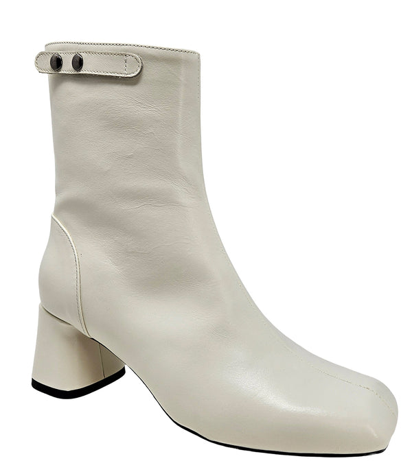 Handcrafted ankle boot made in Italy, designed with a smooth leather finish, square toe, side zipper closure, and a flared block heel. Features a decorative strap with metal accents. Shown from multiple angles against a clean background