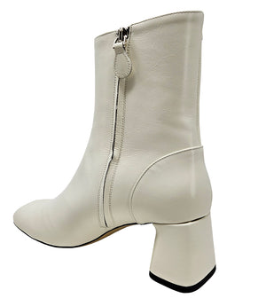 Handcrafted ankle boot made in Italy, designed with a smooth leather finish, square toe, side zipper closure, and a flared block heel. Features a decorative strap with metal accents. Shown from multiple angles against a clean background